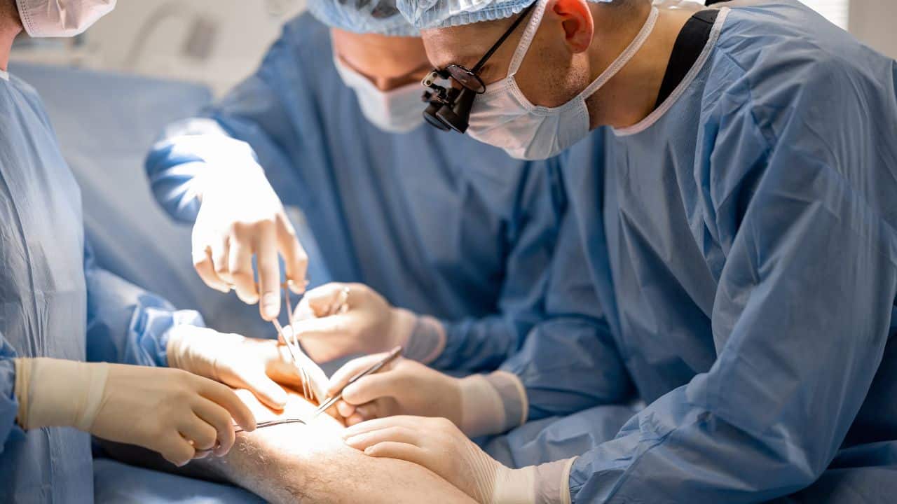 surgeons performing surgical operation on a patient's knee